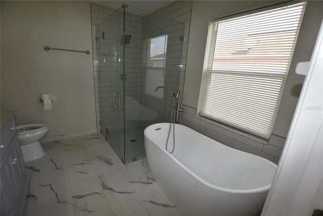 a bathroom with a bathtub and toilet