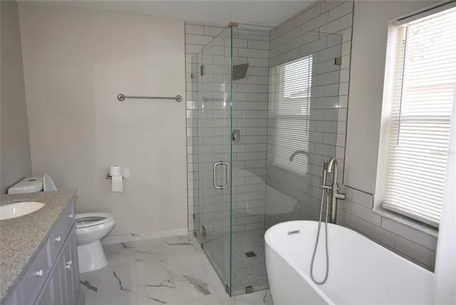a bathroom with a toilet and shower