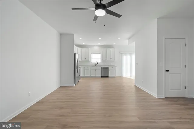 a view of a kitchen with a sink and a refrigerator