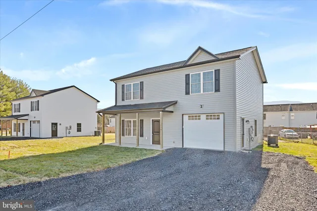 a view of a house with a swimming pool and a yard