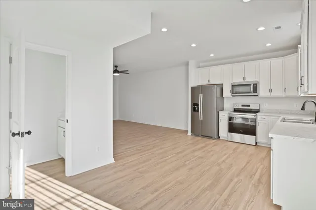 a kitchen with stainless steel appliances a refrigerator and a stove top oven