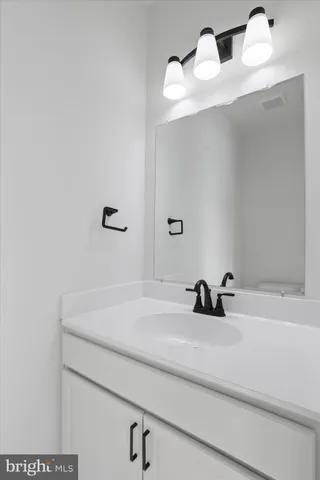 a bathroom with a sink and mirror