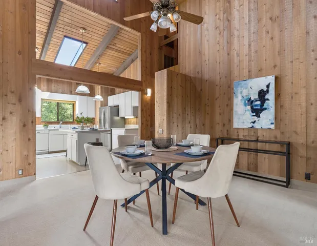 a view of a dining room with furniture and chandelier