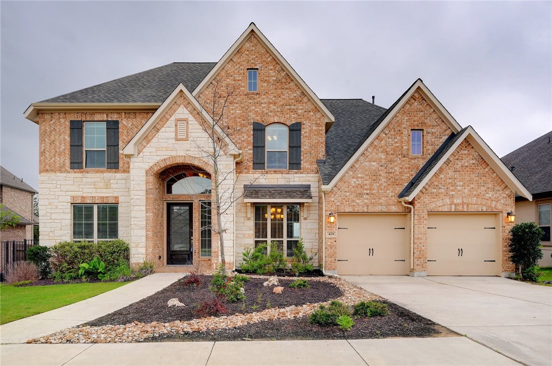 a front view of a house with a yard and garage