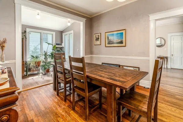 a dining room with furniture and wooden floor