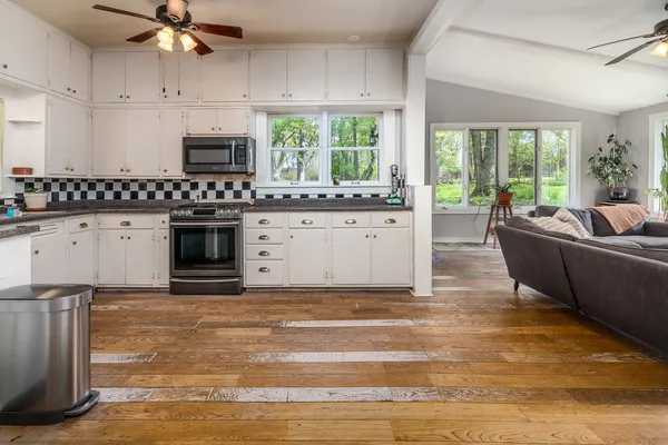a kitchen with stainless steel appliances granite countertop a stove a sink and a refrigerator