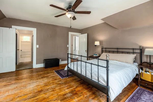 a spacious bedroom with a bed and a chandelier