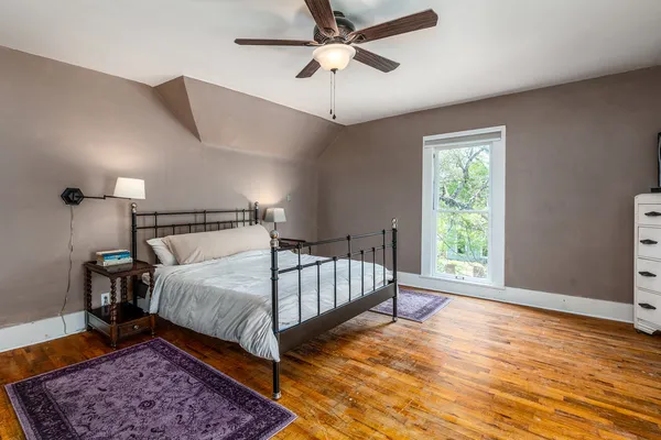a bedroom with a bed and a chandelier