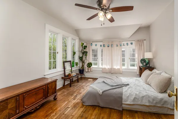 a spacious bedroom with a bed and a window