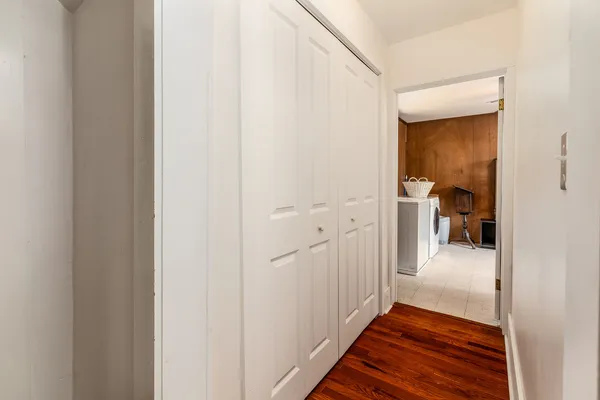 a view of a hallway view with wooden floor and staircase