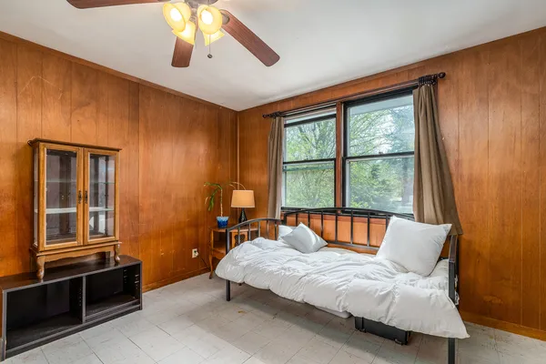 a bedroom with a bed and window