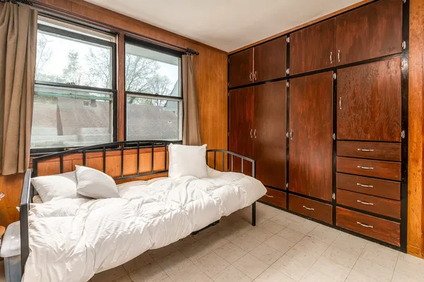 a bedroom with a bed window and a walk in closet
