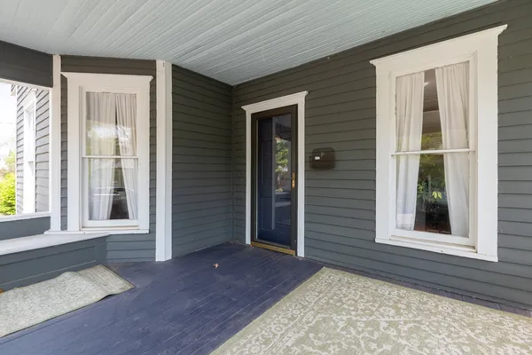 a view of a house with a wooden deck