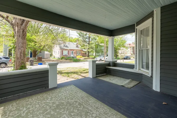 a living room with hardwood floor and a large window