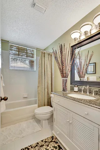 a bathroom with a toilet a sink and a mirror