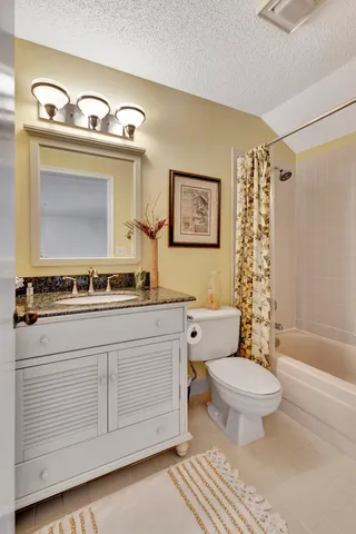 a kitchen with stainless steel appliances granite countertop a sink a stove a refrigerator cabinets and chairs