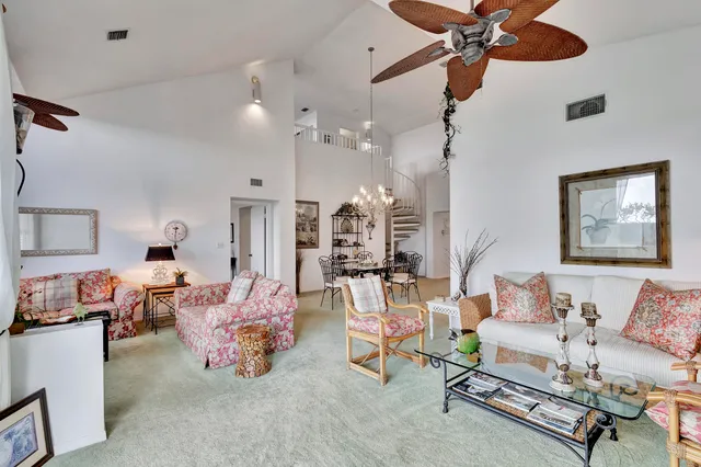 a view of a dining room with furniture and a chandelier