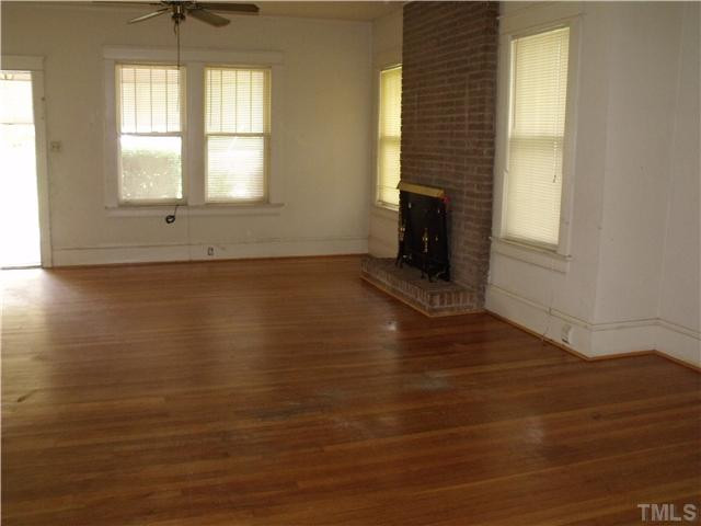 2909 Garner Road Raleigh, NC 27610 - Photo 3 of 8 an empty room with wooden floor and windows