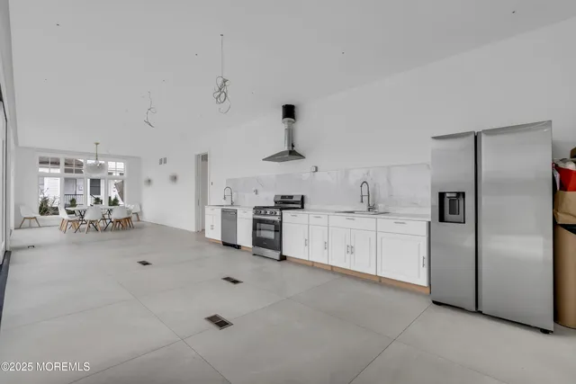 a kitchen with refrigerator and cabinets