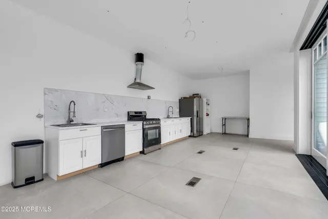 a kitchen with white cabinets and white appliances