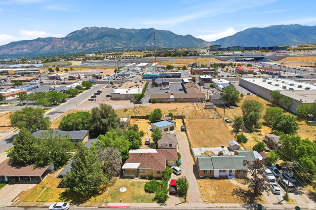 5480 South 2000th Street West Roy, UT 84067 - Photo 33 of 36 Aerial perspective showcasing a residential area with varied housing styles and mature trees