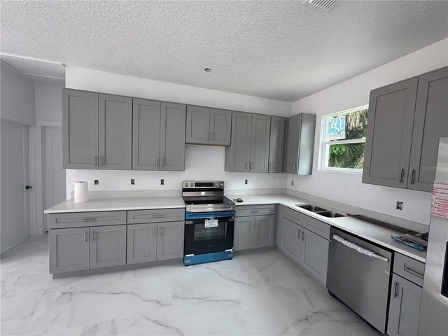 a kitchen that has a sink and a stove in it