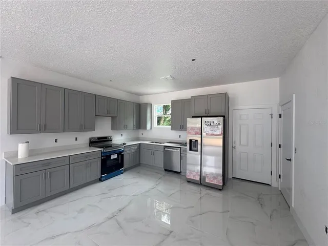 a kitchen with cabinets and window