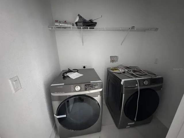 a utility room with dryer and washer