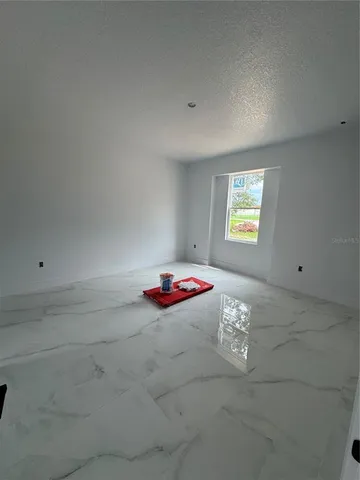 a view of a room that has a rug and window
