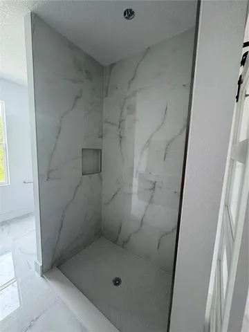 a bathroom with a glass door shower