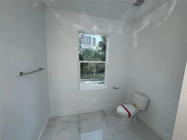 a view of a room with window and lounge chair