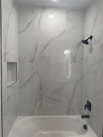 a bathroom with a shower and a bathtub