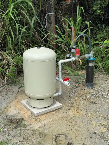 a view of a house with big yard and large trees