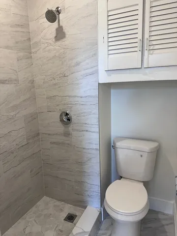 a kitchen with sink a microwave and cabinets