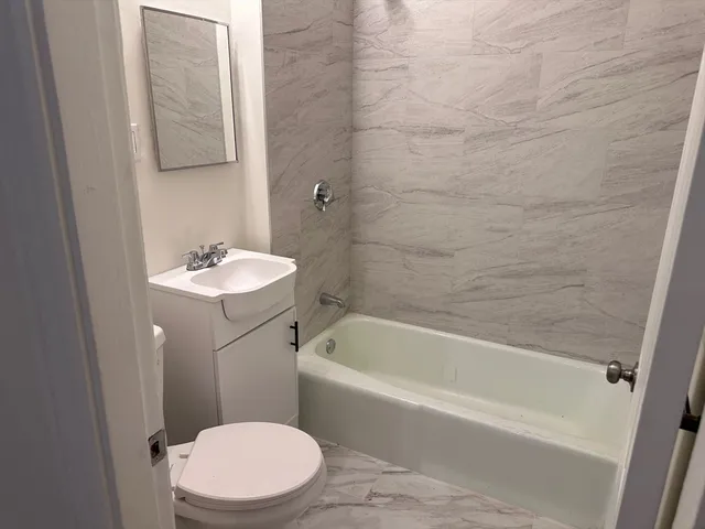 a bathroom with a sink a toilet and bathtub