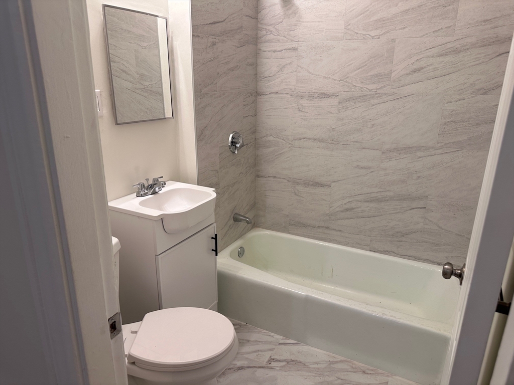 27 Bailey Street, Unit 2 Boston, MA 02124 - Photo 5 of 12 a bathroom with a sink a toilet and bathtub