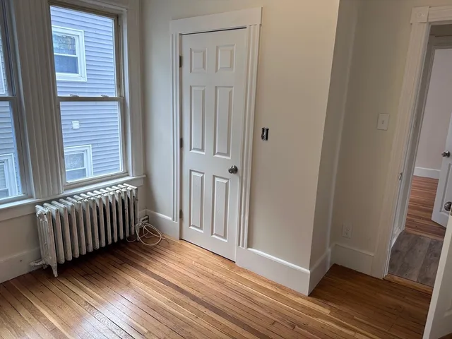 a view of a livingroom with wooden floor and staircase