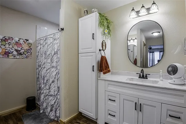 a bathroom with a double vanity sink and a mirror