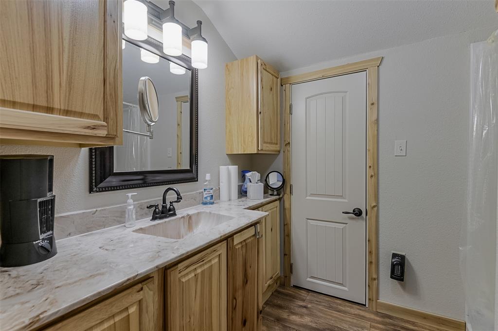 2683 Bells Chapel Road Palmer, TX 75152 - Photo 16 of 28 a bathroom with a granite countertop sink and a mirror