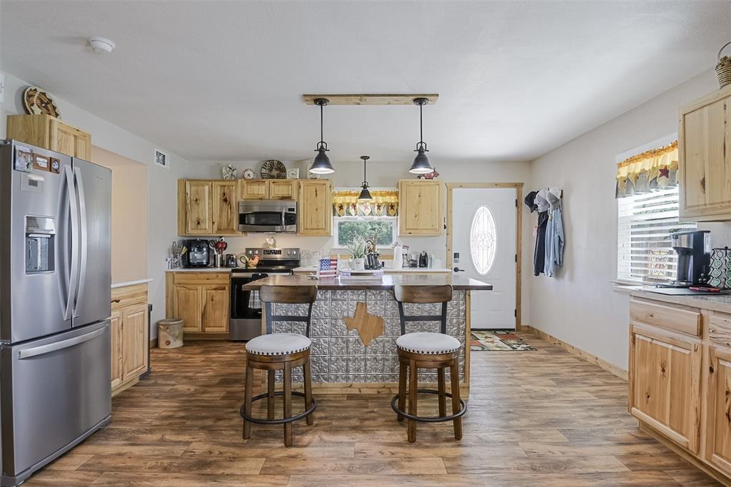 2683 Bells Chapel Road Palmer, TX 75152 - Photo 7 of 28 a kitchen with refrigerator and chairs