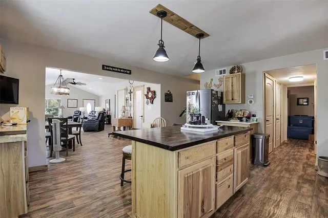 a kitchen with stainless steel appliances granite countertop a sink stove and wooden floor
