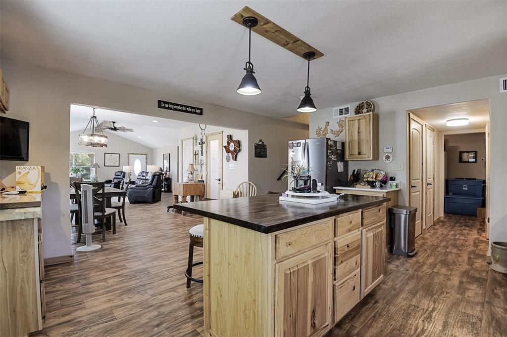 2683 Bells Chapel Road Palmer, TX 75152 - Photo 9 of 28 a kitchen with stainless steel appliances granite countertop a sink stove and wooden floor