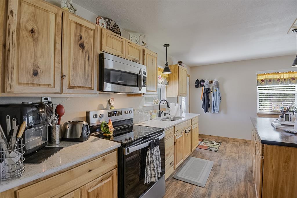 2683 Bells Chapel Road Palmer, TX 75152 - Photo 10 of 28 a kitchen with stainless steel appliances granite countertop a sink stove and refrigerator