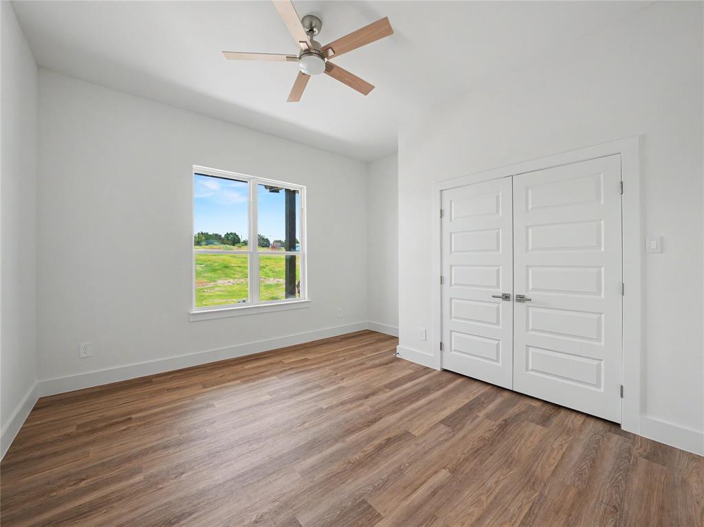328 Slimp Bluff Azle, TX 76020 - Photo 22 of 30 Room featuring wood-finish flooring, a contemporary ceiling fan, and white baseboards