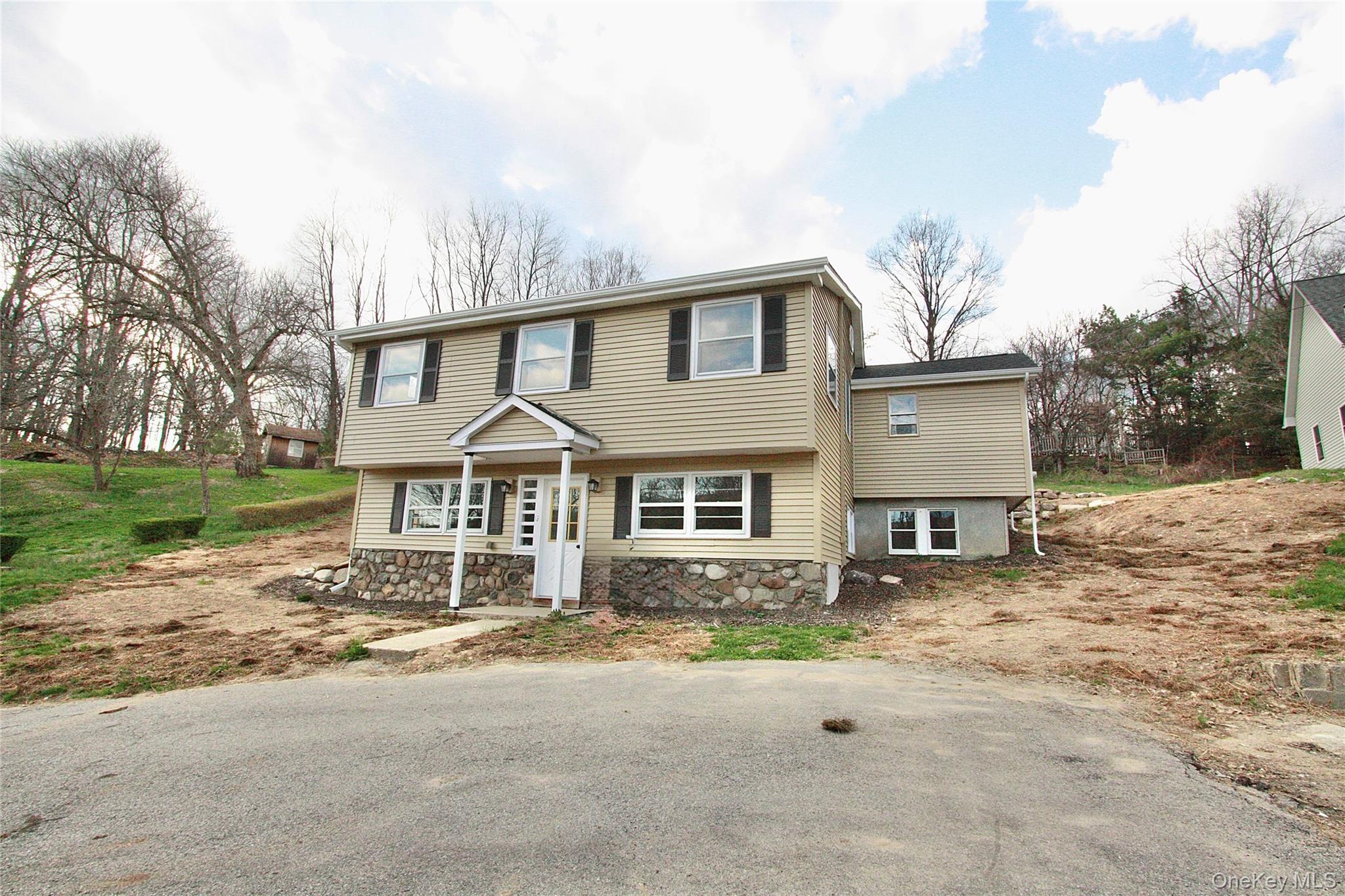12 Clove Road Salisbury Mills, NY 12577 - Photo 2 of 28 a front view of a house with a yard and garage