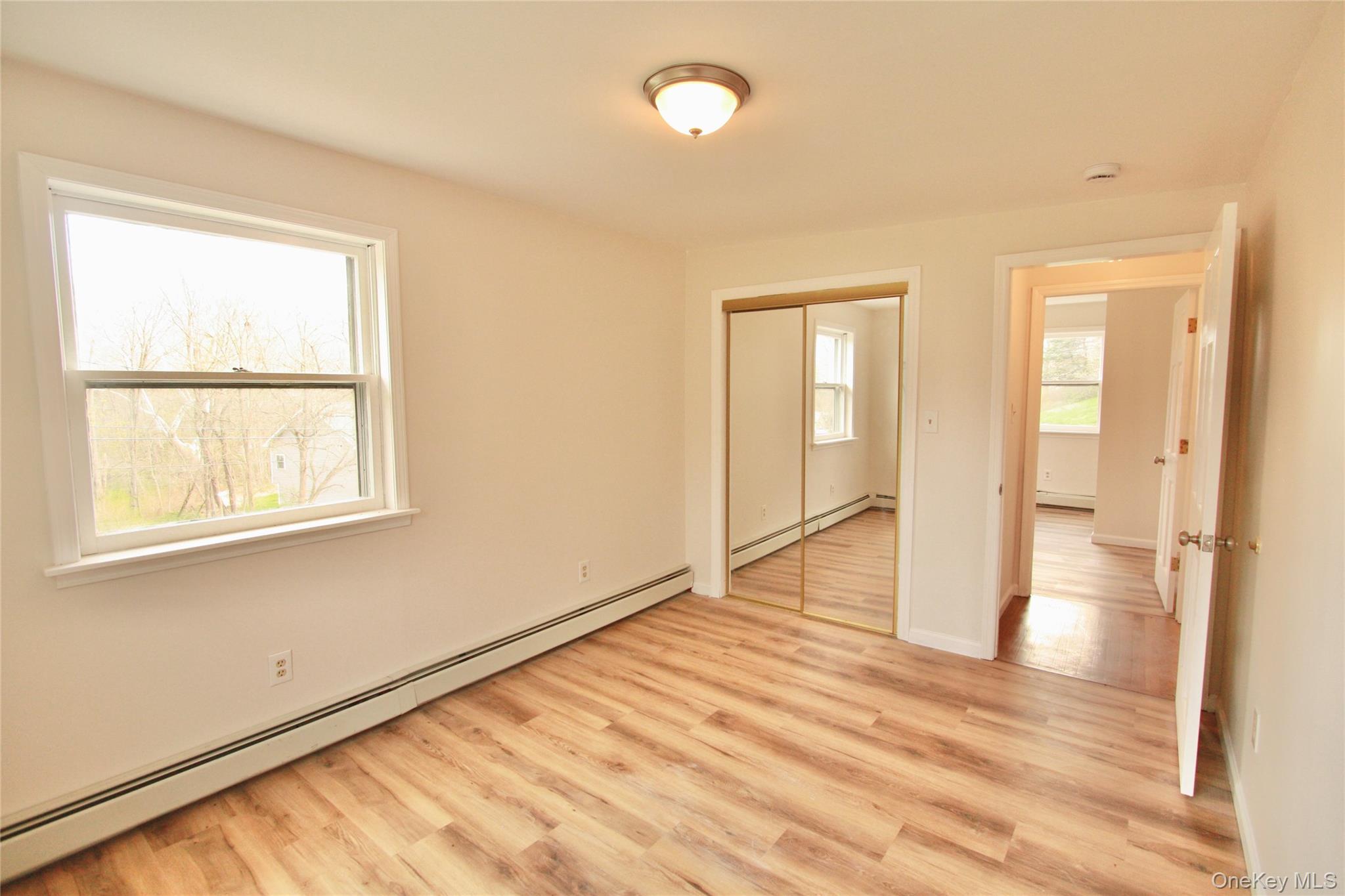 12 Clove Road Salisbury Mills, NY 12577 - Photo 21 of 28 a view of an empty room with wooden floor and a window