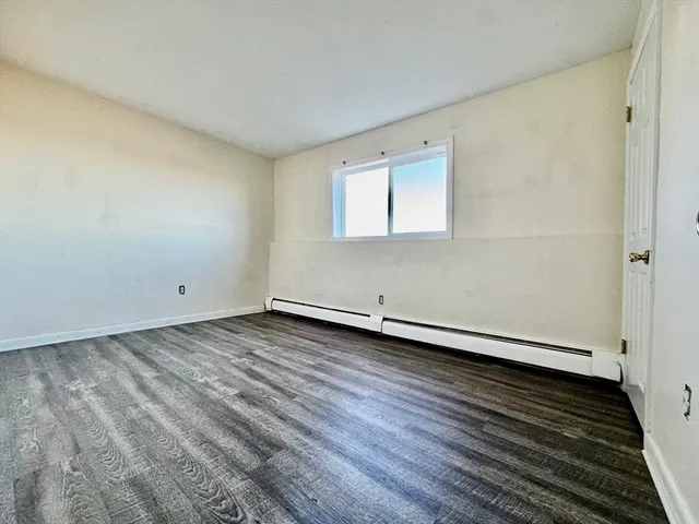 a view of an empty room and wooden floor
