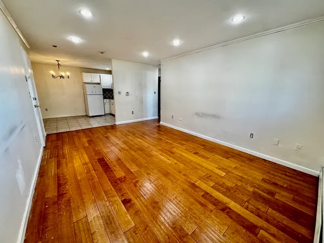 a kitchen with a sink a refrigerator and cabinets
