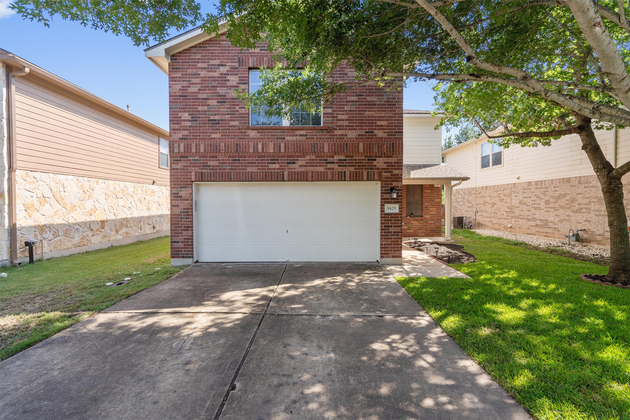 5825 Silver Screen Drive Austin, TX 78747 - Photo 1 of 40 A classic brick facade welcomes you home, complete with an attached garage and a neatly maintained lawn.