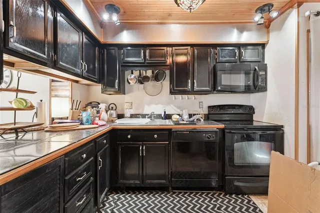 a kitchen with stainless steel appliances granite countertop a stove and cabinets